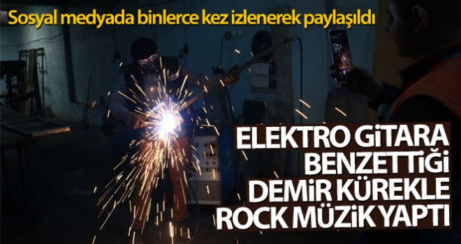 Elektro gitara benzettiği demir kürekle rock müzik yaptı